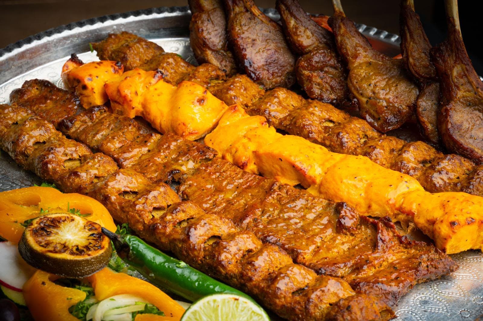 Charcoal grilled Persian kebabs on a silver tray