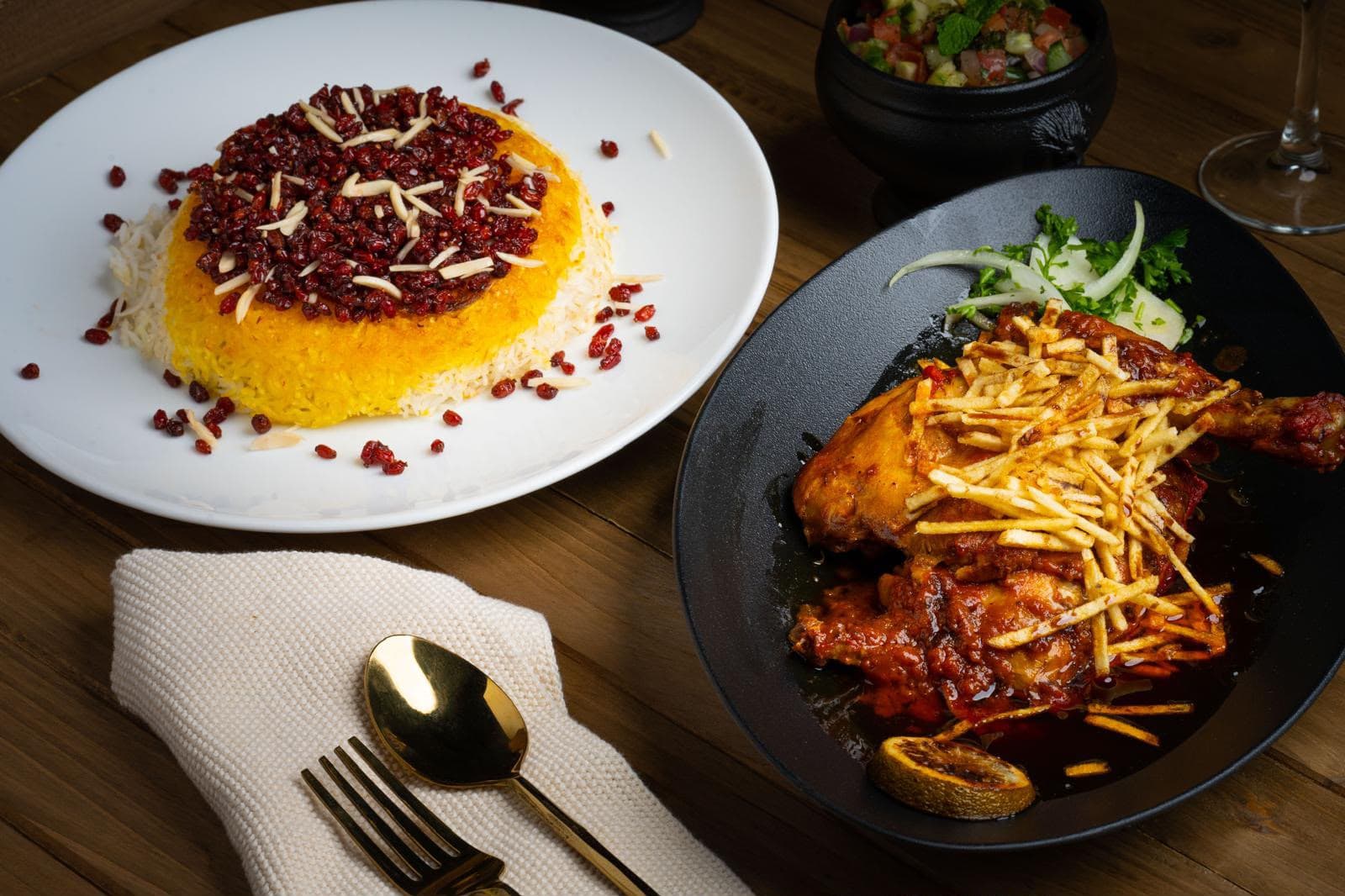 Zereshk polo with barberries and chicken in tomato sauce